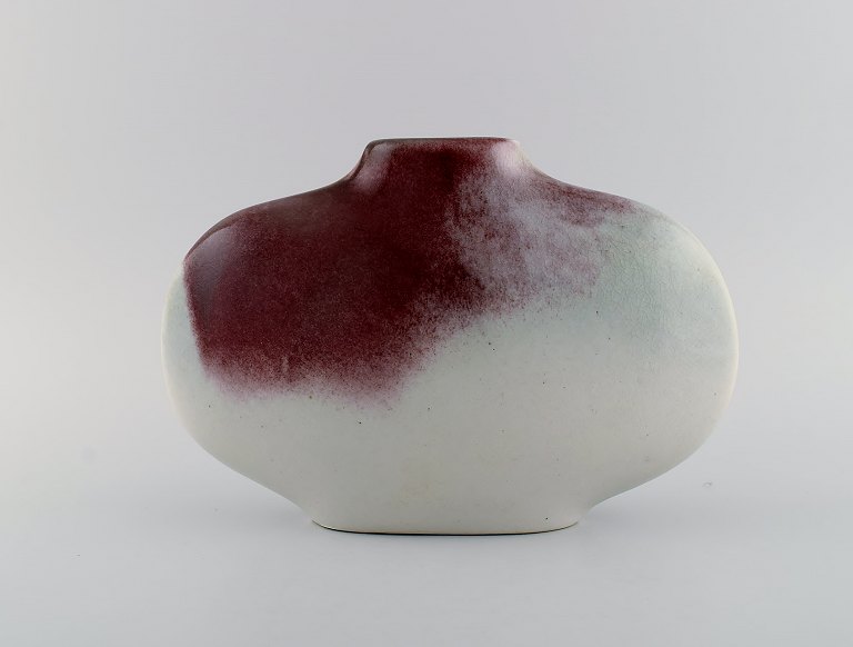 European studio ceramicist. Unique vase in glazed ceramics. Beautiful glaze in 
purple and light sand shades. Late 20th century.
