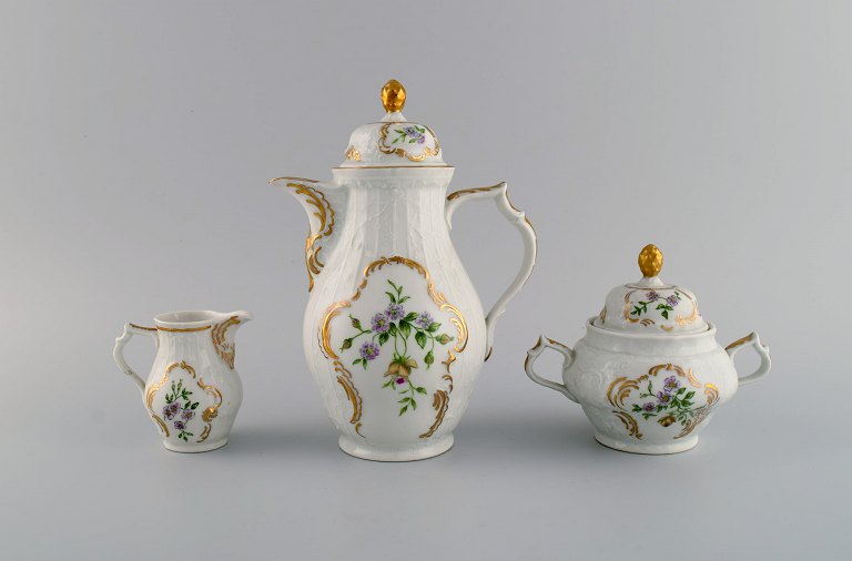 Rosenthal Sans Souci coffee pot, sugar bowl and cream jug. Hand-painted flowers, 
foliage in relief and gold edge. 1950s.
