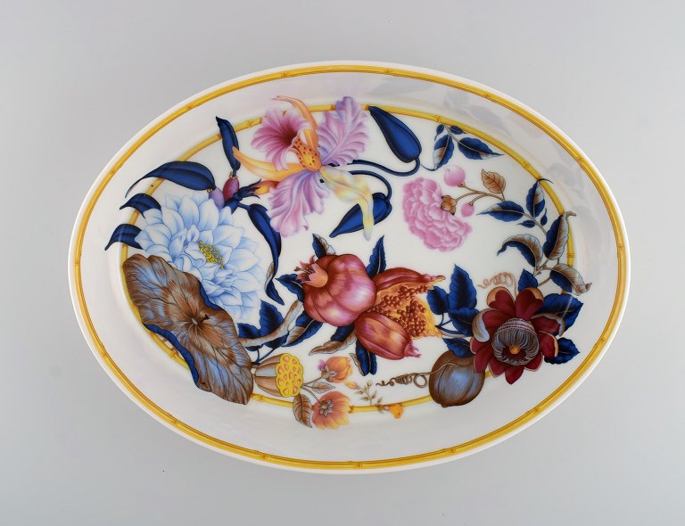 Porcelain of Paris. "Tropical Aurore". Large porcelain dish decorated with 
flowers, pomegranates and bamboo. 1980s.

