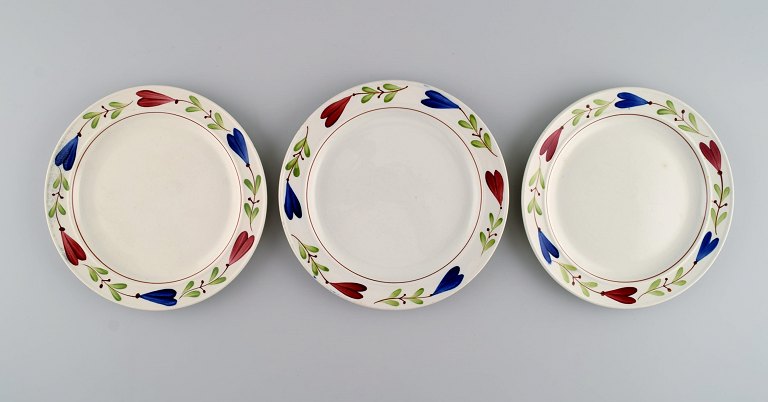 Stig Lindberg (1916-1982) for Gustavsberg. Three Ranka porcelain dinner plates 
with hand-painted flowers and foliage. Mid 20th century.
