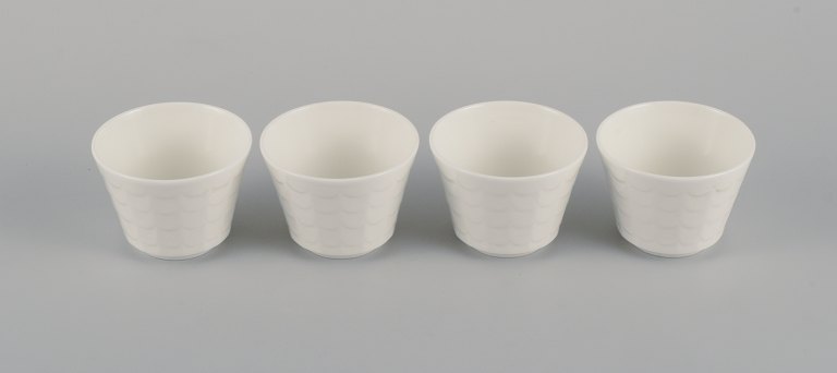 Wilhelm Kåge for Gustavsberg. Four flower pot covers in porcelain. Swedish 
design, 1960s.