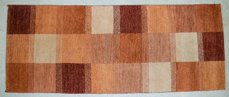 Milford, Sweden, pure wool rug. Geometric fields in red, orange and white 
shades.