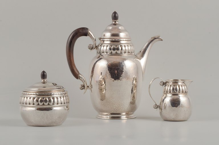 Rare Georg Jensen coffee pot with matching creamer and sugar bowl in 
sterlingsilver and three-towered silver (830 silver).