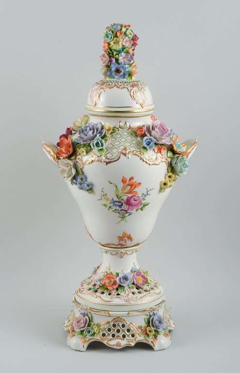 Dresden, kolossal lågpokal på fod i porcelæn. Tre dele.
Overdådigt dekoreret med blomster i relief, håndmalet.
Imponerende vase af høj kvalitet.