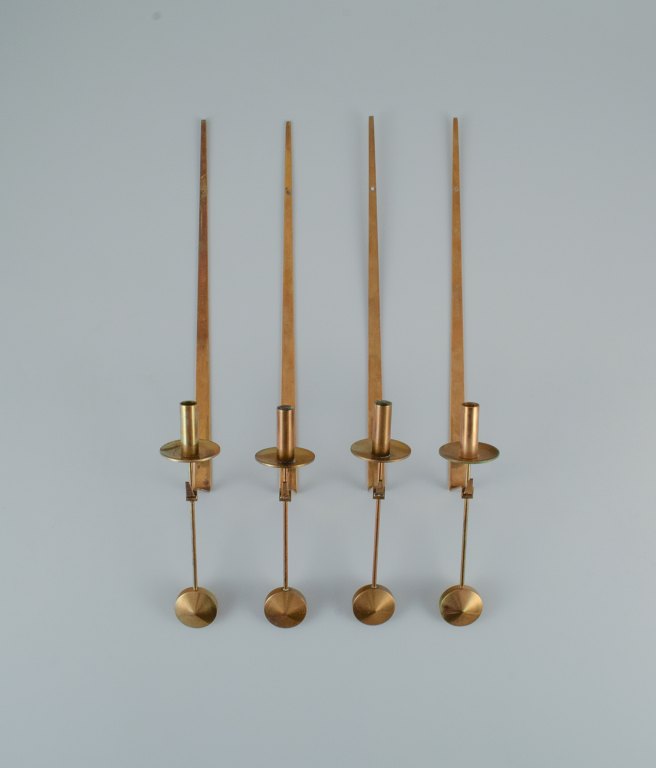 Skultuna, Sweden, four brass candlesticks for wall hanging.
Designer by Pierre Forsell.
