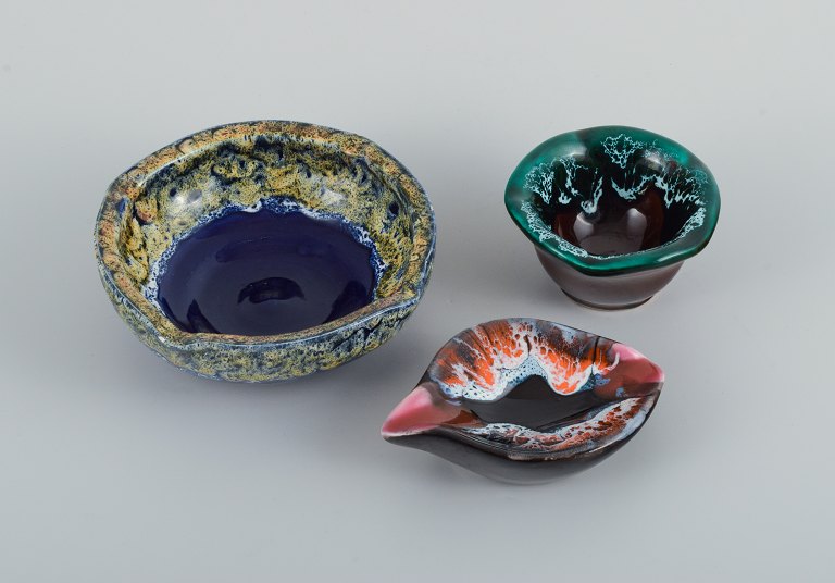 Vallauris, France, three ceramic bowls in brightly colored glazes.