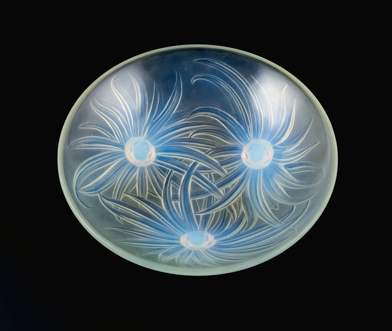 Etling, France, art nouveau bowl of iridescent art glass with floral decoration 
in relief, on three feet.