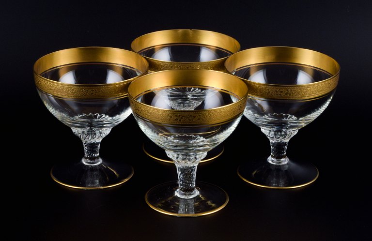 Rimpler Kristall, Zwiesel, Germany, four mouth-blown crystal champagne glasses 
with gold rim decorated with grapes and vine leaves.