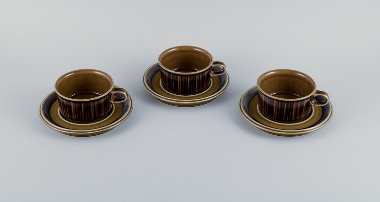 Gunvor Olin-Grönqvist for Arabia, "Cosmos," three sets of tea cups with  
saucers. Stoneware in a retro style. Glazed in green-brown tones.