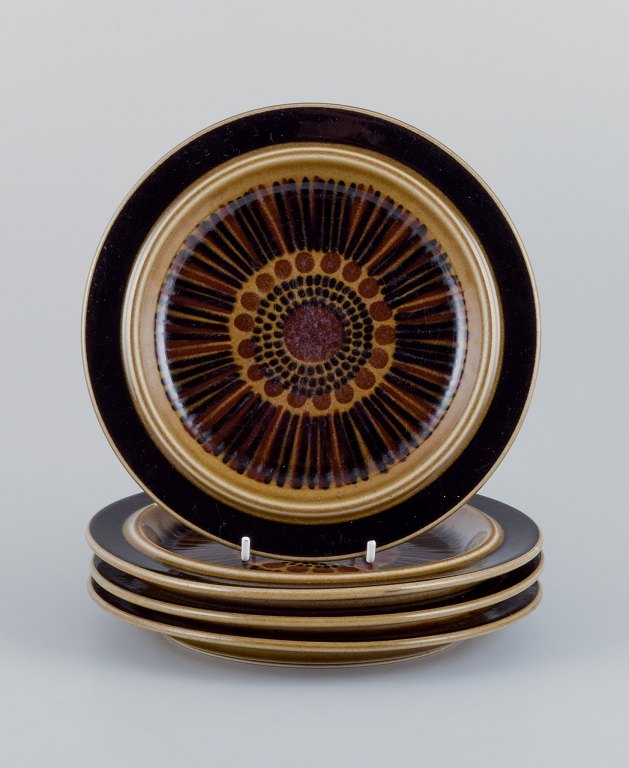 Gunvor Olin-Grönqvist for Arabia, "Cosmos", a set of four lunch plates in 
stoneware. Retro-style stoneware with green-brown glaze.