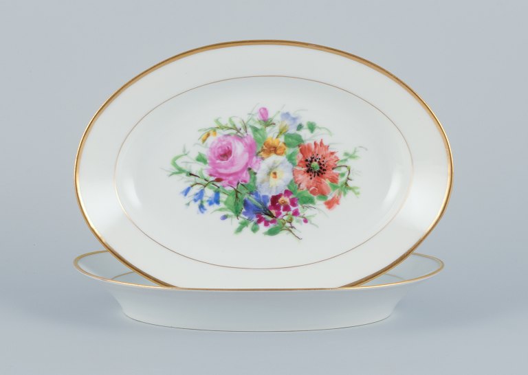 Bing & Grondahl, two oval platters hand-painted with polychrome flower motifs 
and gold trim.
