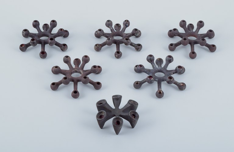 Jens Harald Quistgaard for Dansk Designs, a set of six candle holders in cast 
iron.