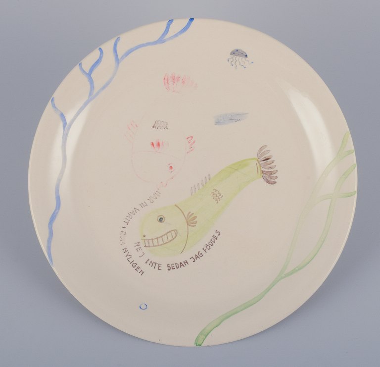 Stig Lindberg for Gustavsberg. "Löja" plate. Hand-painted with a fish motif. 
Satirical illustration with Swedish text.