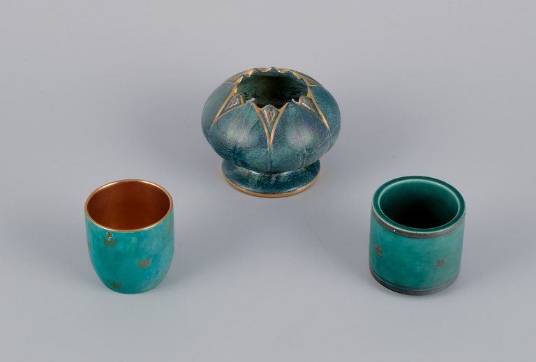 Josef Ekberg and Wilhelm Kåge for Gustavsberg, Sweden. A set of three small 
vases in different sizes. Green glaze with flower motifs inlaid in silver and 
gold.