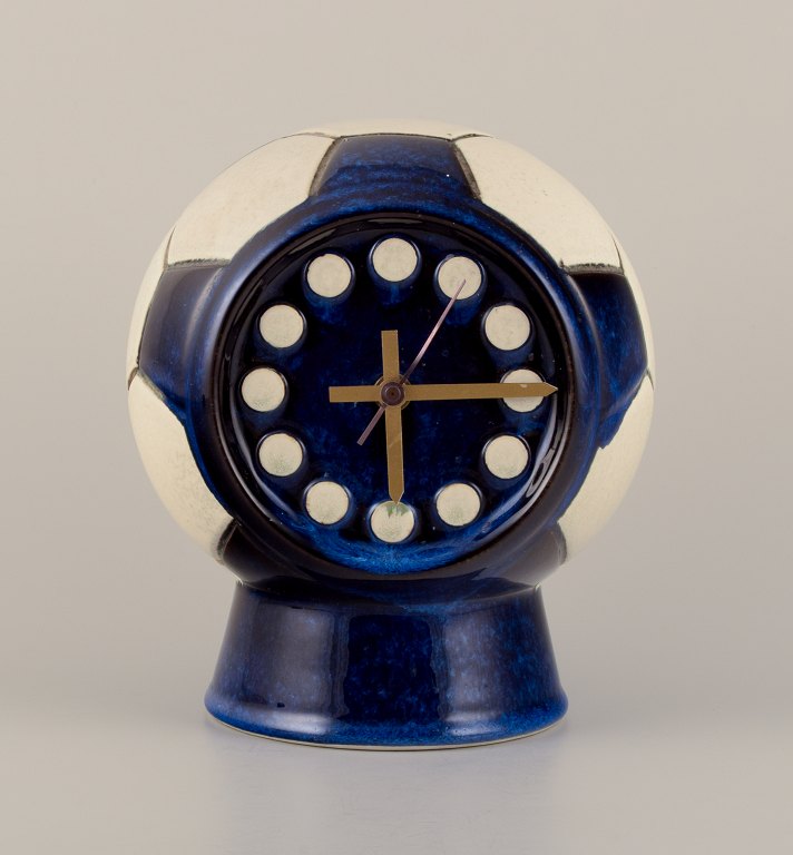 Berit Sundell for Gustavsberg, Sweden. Unique ceramic tabletop clock designed in 
the shape of a soccer ball. Brass hands.