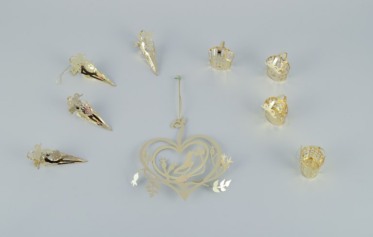 Royal Copenhagen "Royal Christmas". Set of nine brass Christmas ornaments for 
hanging on the Christmas tree and in the window.