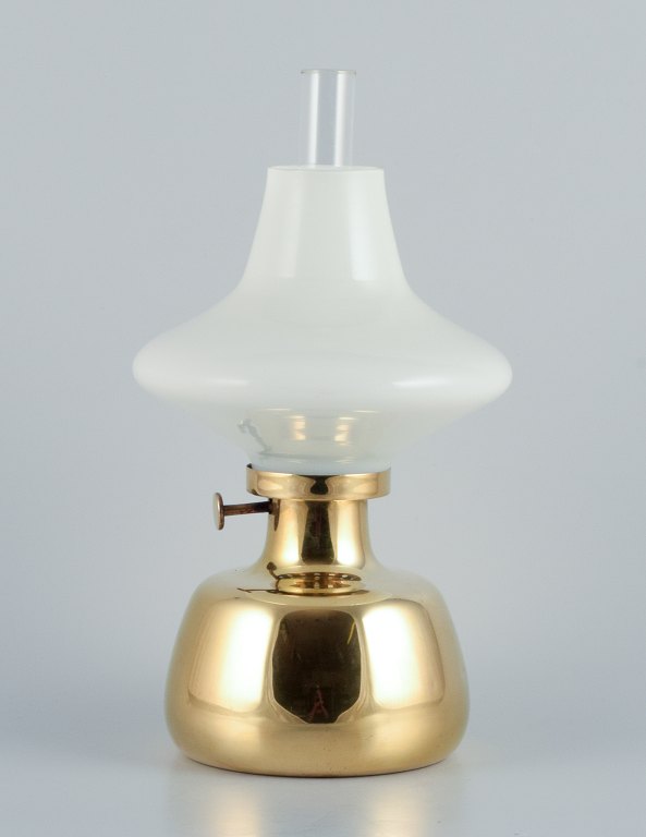 Henning Koppel for Louis Poulsen. Petronella oil lamp in brass with an opal 
glass shade.