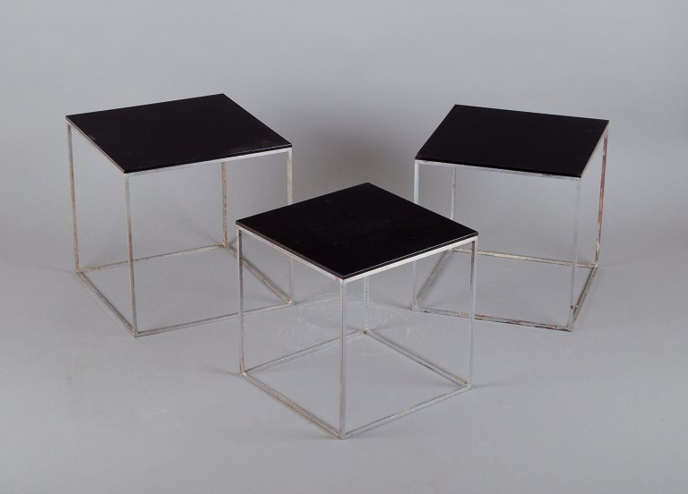 Poul Kjærholm, Danish furniture designer. A set of nesting tables PK 71.
Brushed steel frame, black acrylic tops.