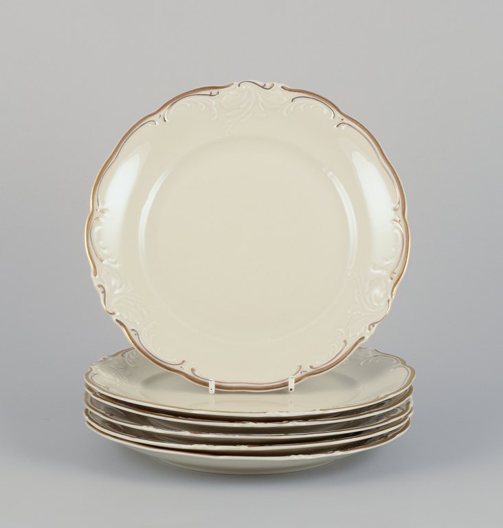 KPM, Poland. A set of six porcelain lunch plates.
Cream-colored with gold rim decoration.