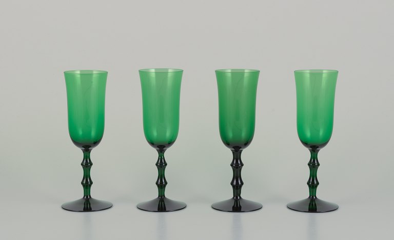 Simon Gate for Orrefors, Sweden. Four "Salut" champagne glasses in green 
mouth-blown art glass.