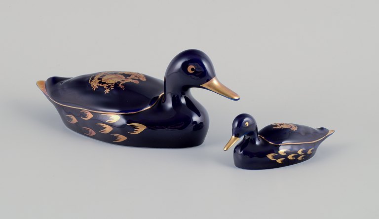 Limoges, France. Two porcelain ducks decorated with 22-karat gold leaf and a 
beautiful royal blue glaze. Scène galante.