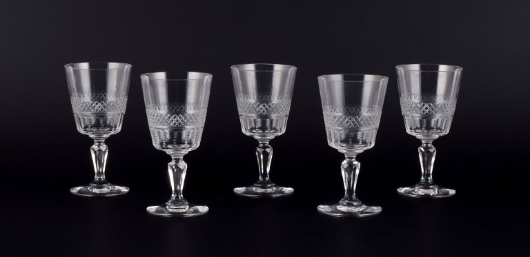 A set of five mouth-blown French white wine glasses in crystal glass. Faceted 
cut.