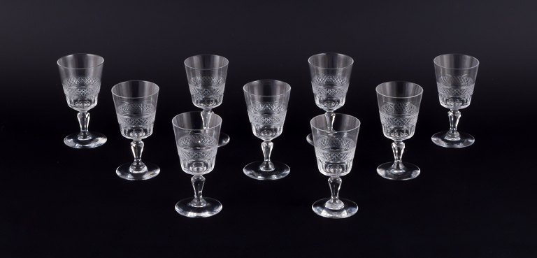 A set of nine mouth-blown French sherry glasses in crystal glass.