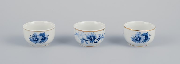 Meissen, Germany. Three small bowls. Hand-decorated with blue floral motifs, 
gold rim.