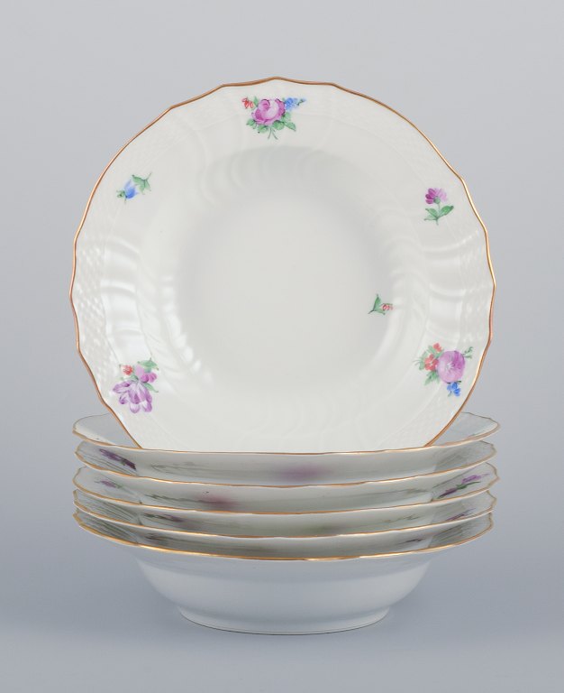 Royal Copenhagen Saxon Flower. Six deep plates in porcelain. Hand-painted with 
polychrome flowers. Gold rim.