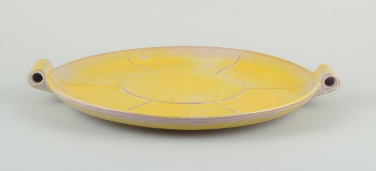 Finnish ceramic dish in Art Deco style. With two handles.Yellow glaze. Hand painted.
