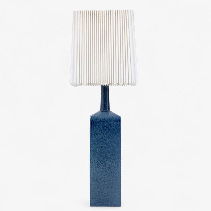 Le Klint
Stor bordlampe i blåglaseret stentøj og plisseret papirskærm. Signeret.
1 stk. på lager
