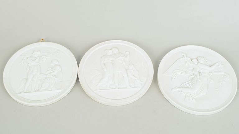Royal Copenhagen, set of three biscuit wall plaques after Thorvaldsen.